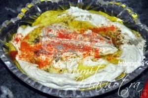 Hummus bi tahini garnished with pimento and za'atar spices