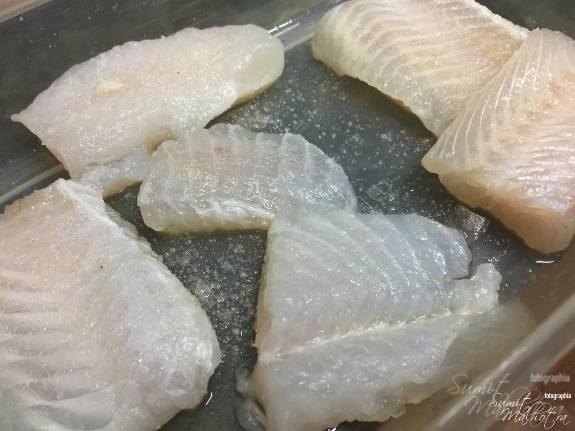 Immerse basa fish in lemon juice and salt