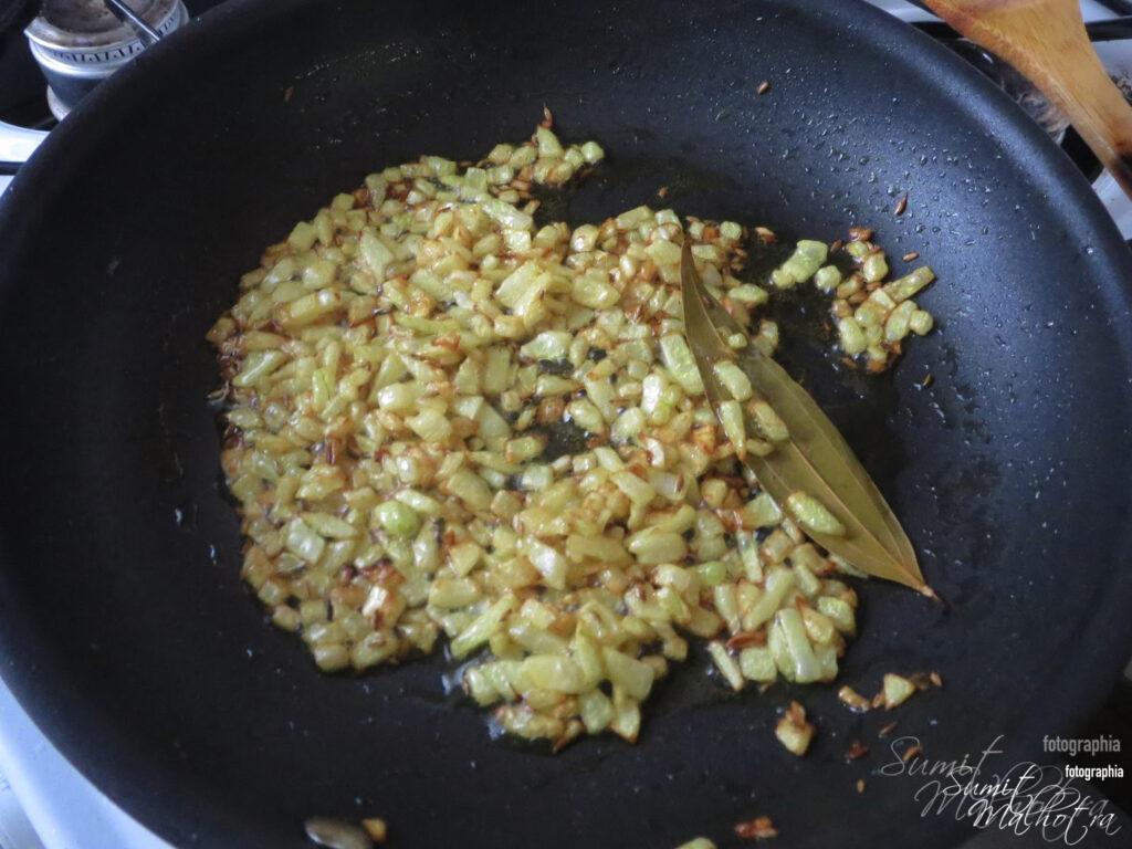 Heat 3 tbsp oil in a pan and add cumin seed, followed by bay leaf and onion over medium flame