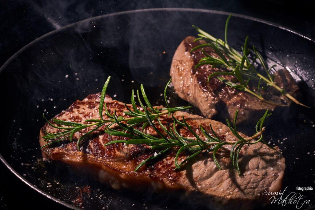 Steak with rosemary on the pan