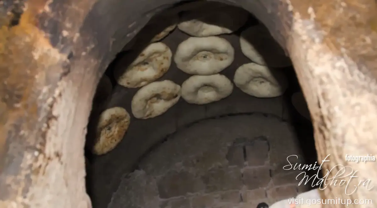 Naan-e-uzbeki in the tandoor Naan-e-uzbeki in the tandoor