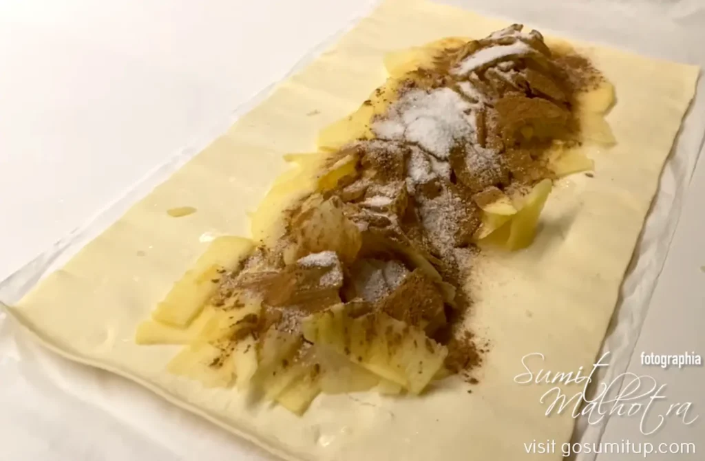 Mastering the apfelstrudel—the physics of viscoelastic pastry stretching Apples with cinnamon & sugar on flour sheet for viennese apfelstrudel