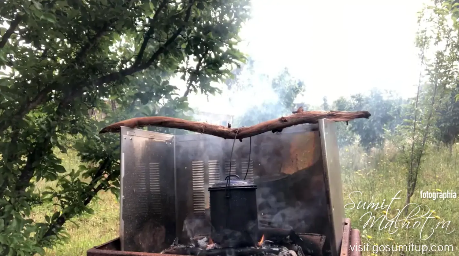 Billy tea kettle being prepared on coals