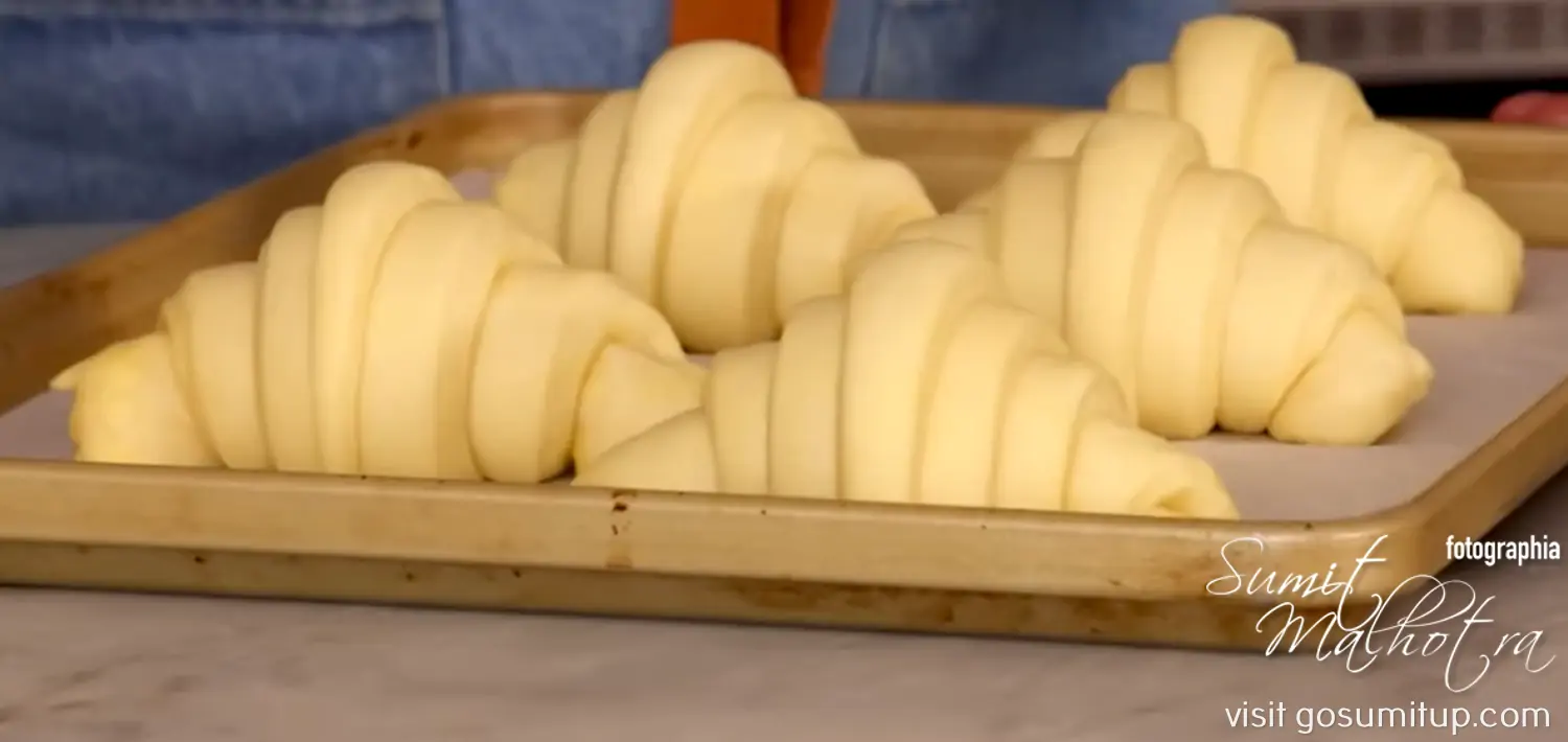 Croissants laid on the baking tray