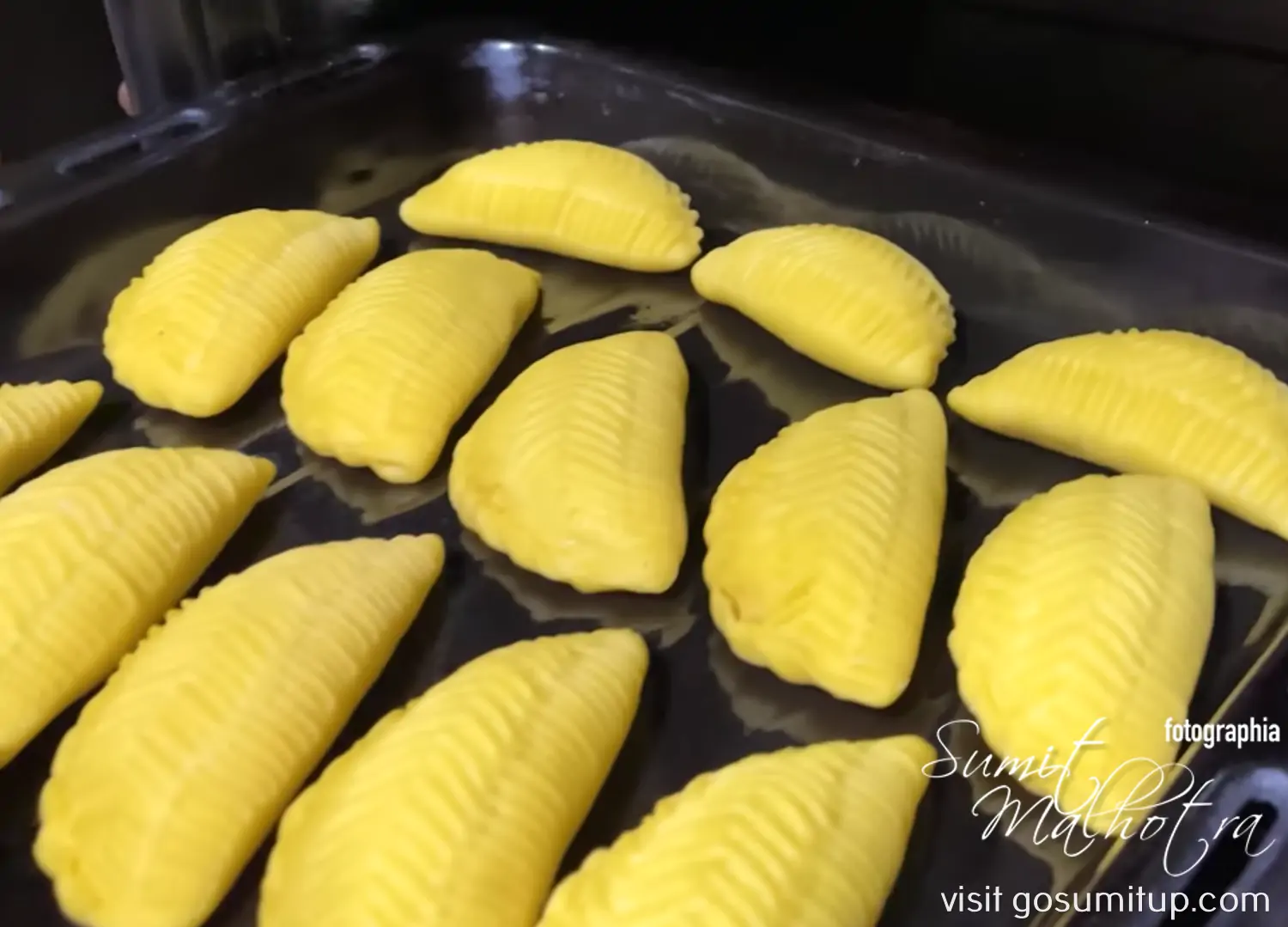 16 traditional shekerbura going into the preheated oven