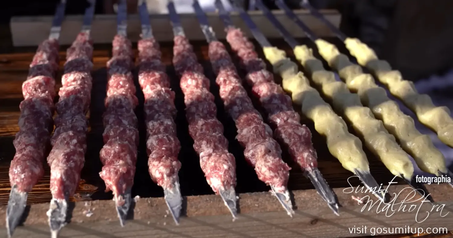 Layer the potatoes & finely minced meat on flat skewers Layer the potatoes & finely minced meat on flat skewers